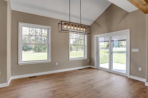 Sunroom with several windows and walkout sliding door