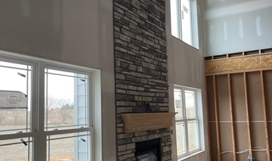 under construction, fireplace with stone to ceiling - windows, side view